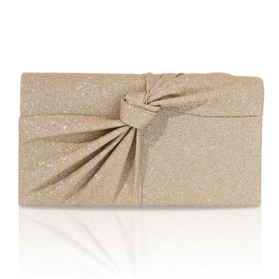 Gold glittery clutch bag with a knot on a white background