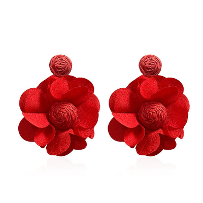 Pair of red floral earrings on a white background